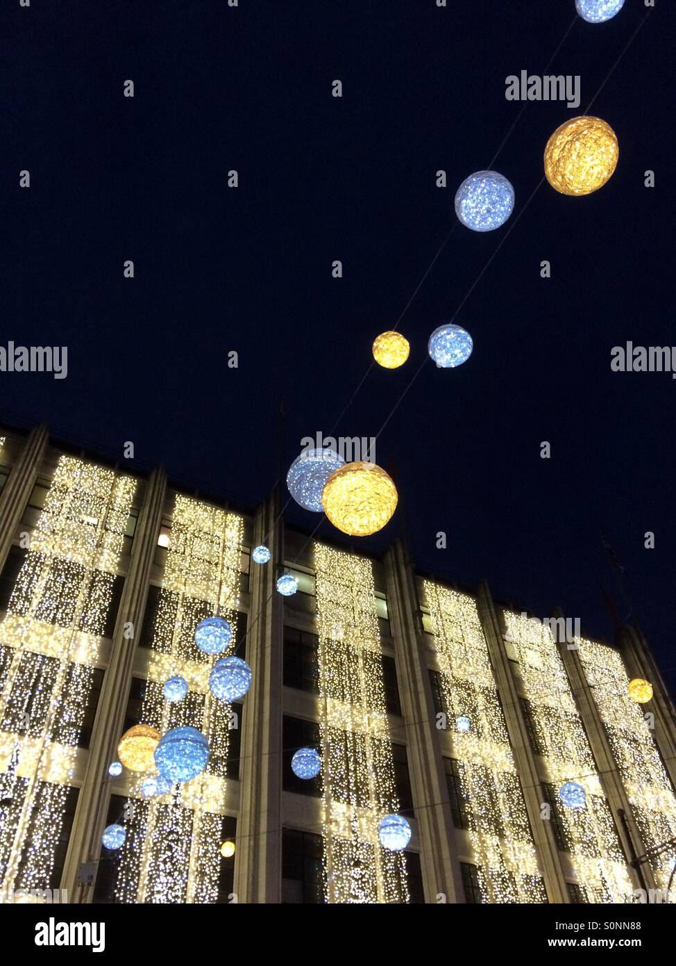 Silver & gold Christmas lights on the House of Fraser building in Oxford Street London UK - Smartphone Captured Stock Image