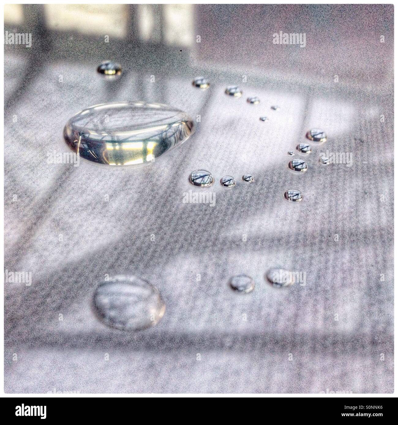 Water droplets on a white canvas - Smartphone Captured Stock Image