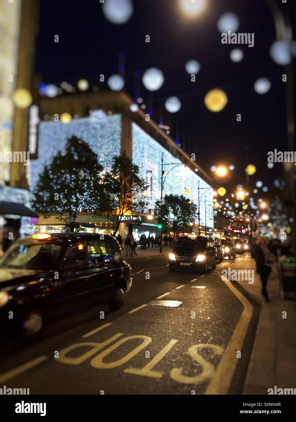 Christmas lights, taxis & buses at night in Oxford Street London UK - Smartphone Captured Stock Image
