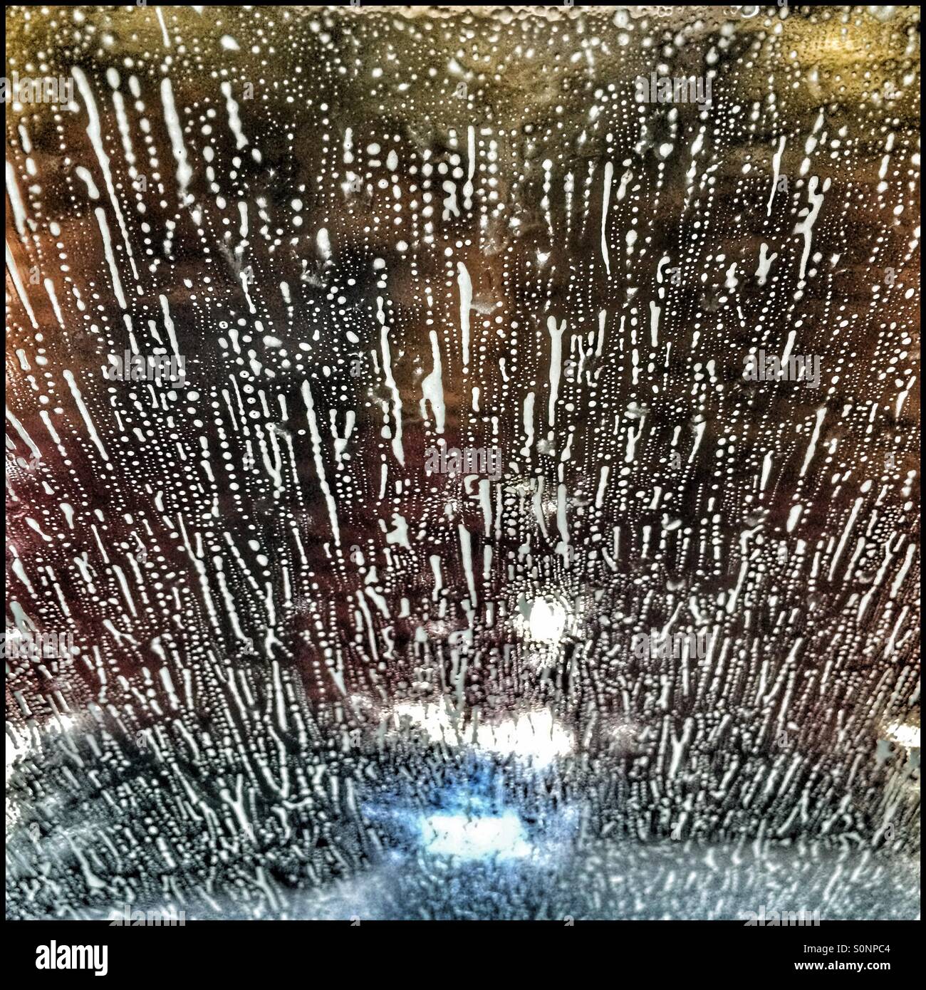 Soap suds on windshield of car in automatic carwash. - Smartphone Captured Stock Image