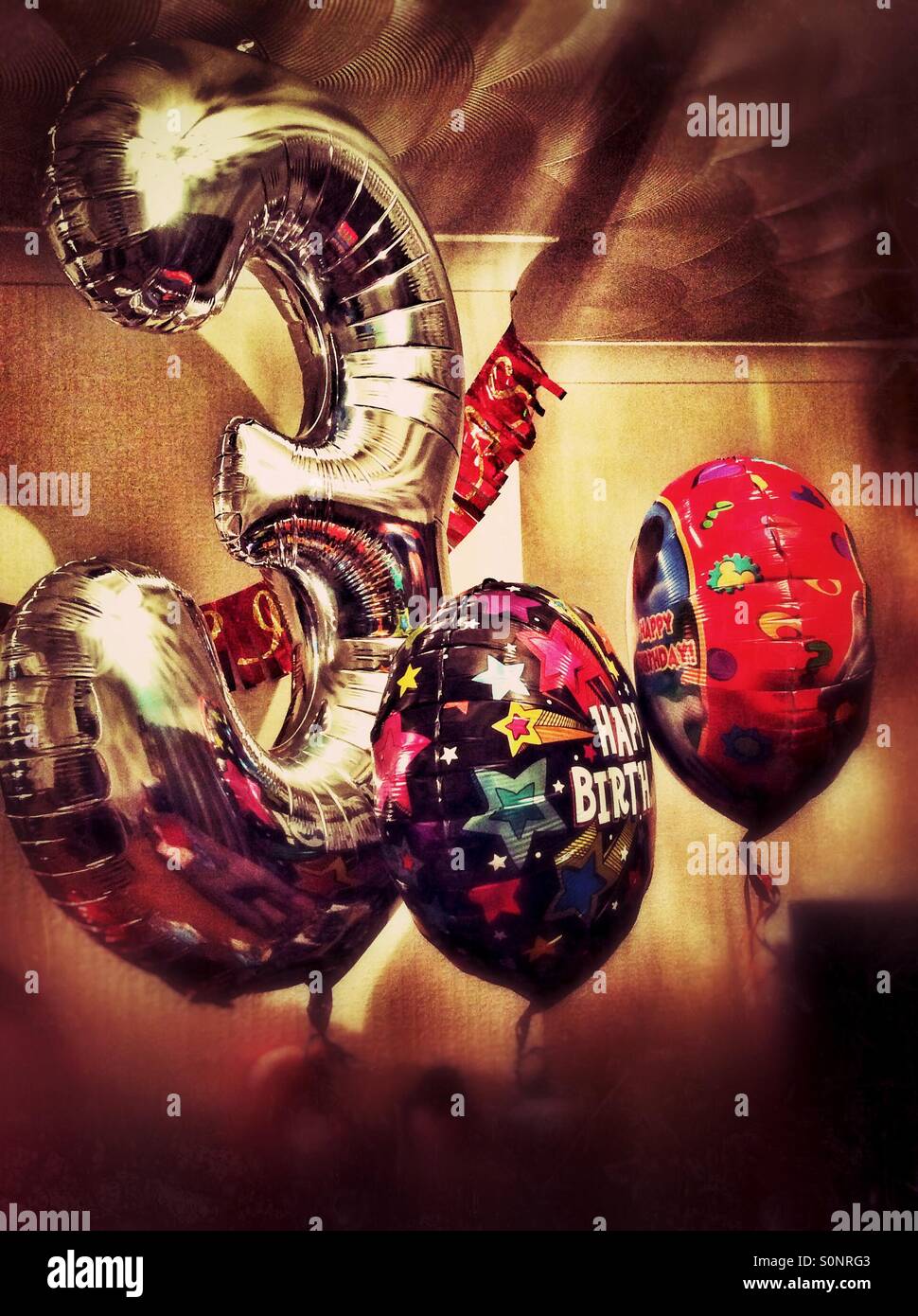 Birthday balloons for a 3rd birthday. - Smartphone Captured Stock Image