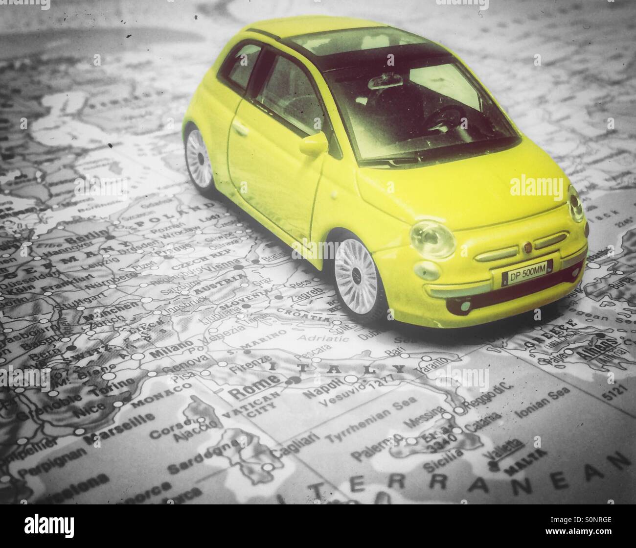 Colour poping of a FIAT 500 on a map of Italy. Stock Photo