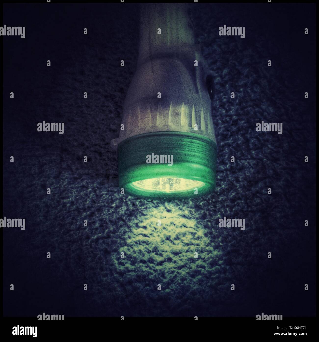 Torch on bed, heavy use of filters. - Smartphone Captured Stock Image Torch on bed, heavy use of filters. - Smartphone Captured Stock Image