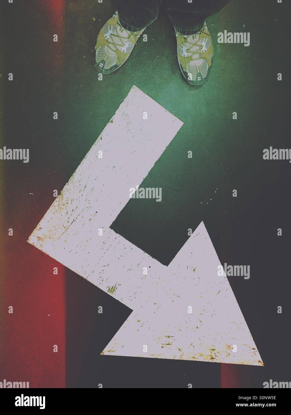 Corner arrow floor sign. Going places. - Smartphone Captured Stock Image