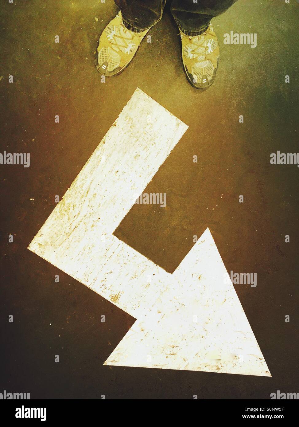 Corner arrow floor sign. Going places. - Smartphone Captured Stock Image