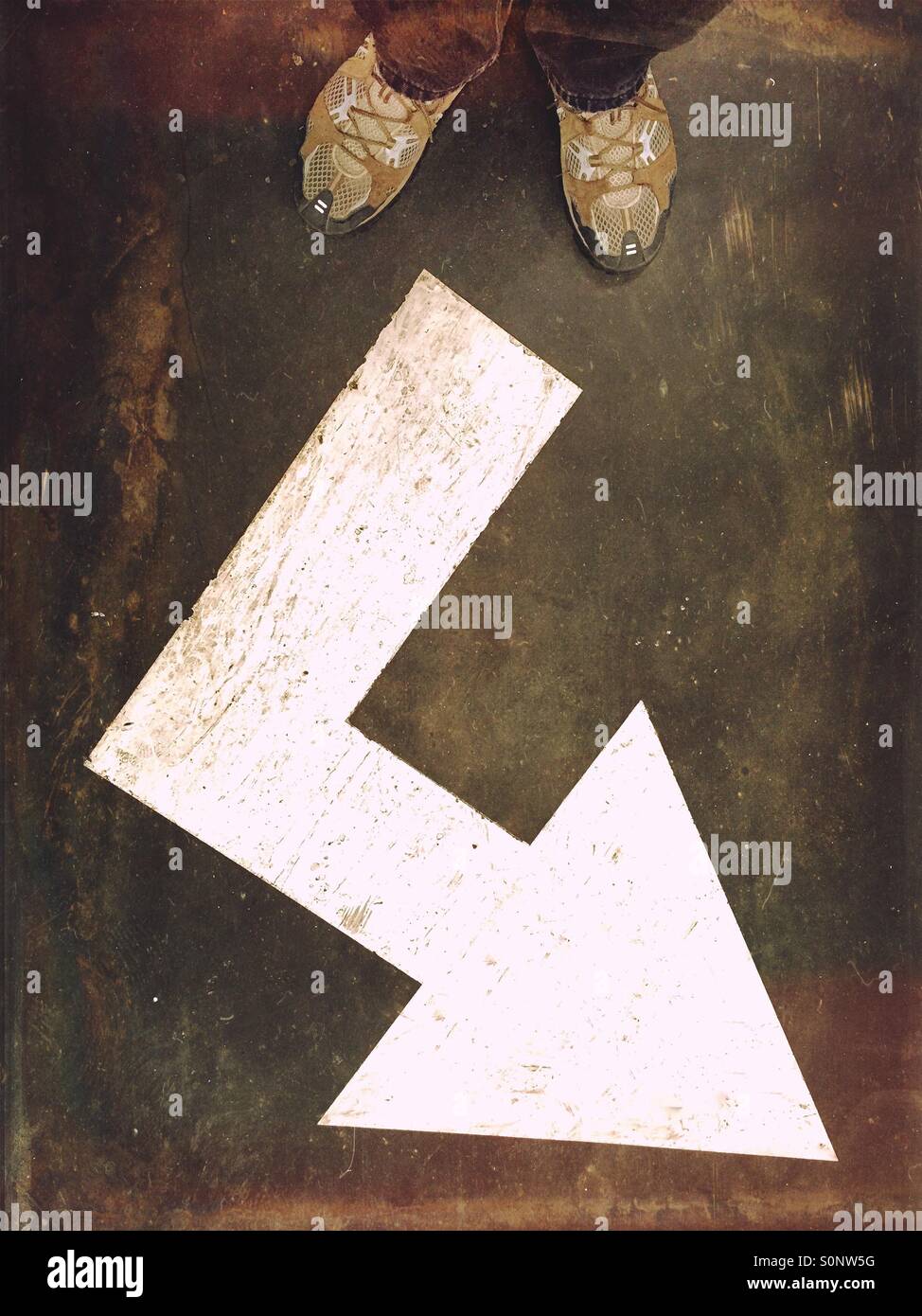 Corner arrow floor sign. Going places. - Smartphone Captured Stock Image