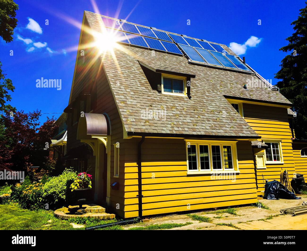 Solar spark. Roof panels on the south side of a single-family home, Ontario, Canada. Small is beautiful. Sunshine. - Smartphone Captured Stock Image