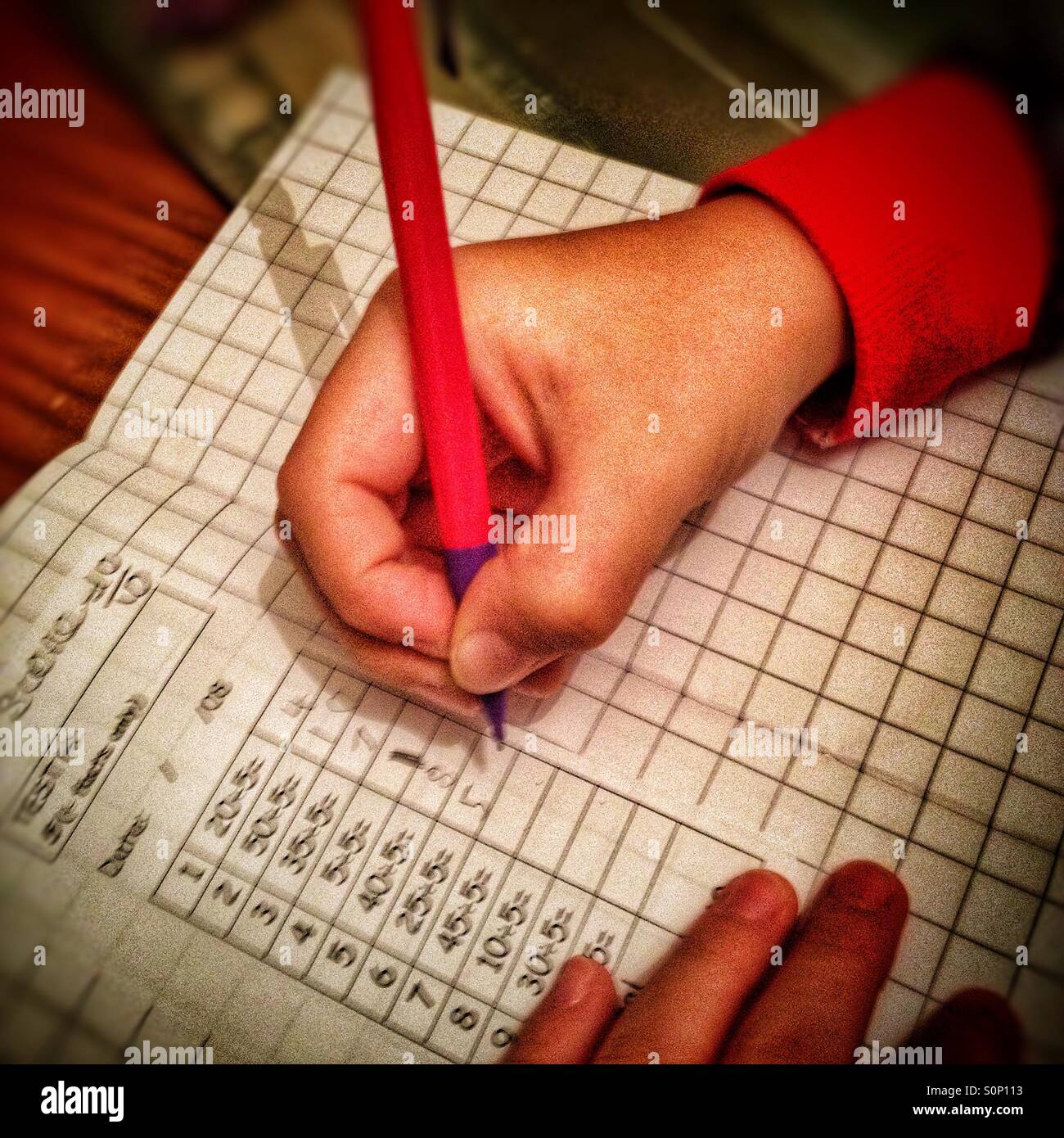 A child doings maths homework. - Smartphone Captured Stock Image