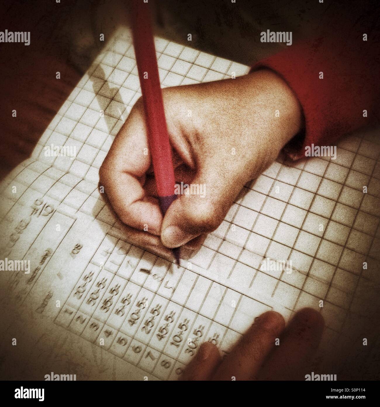 A child doings maths homework. - Smartphone Captured Stock Image