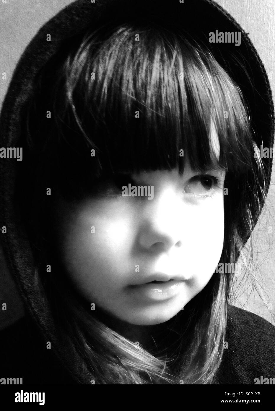 3-year old girl wearing hooded jacket - Smartphone Captured Stock Image