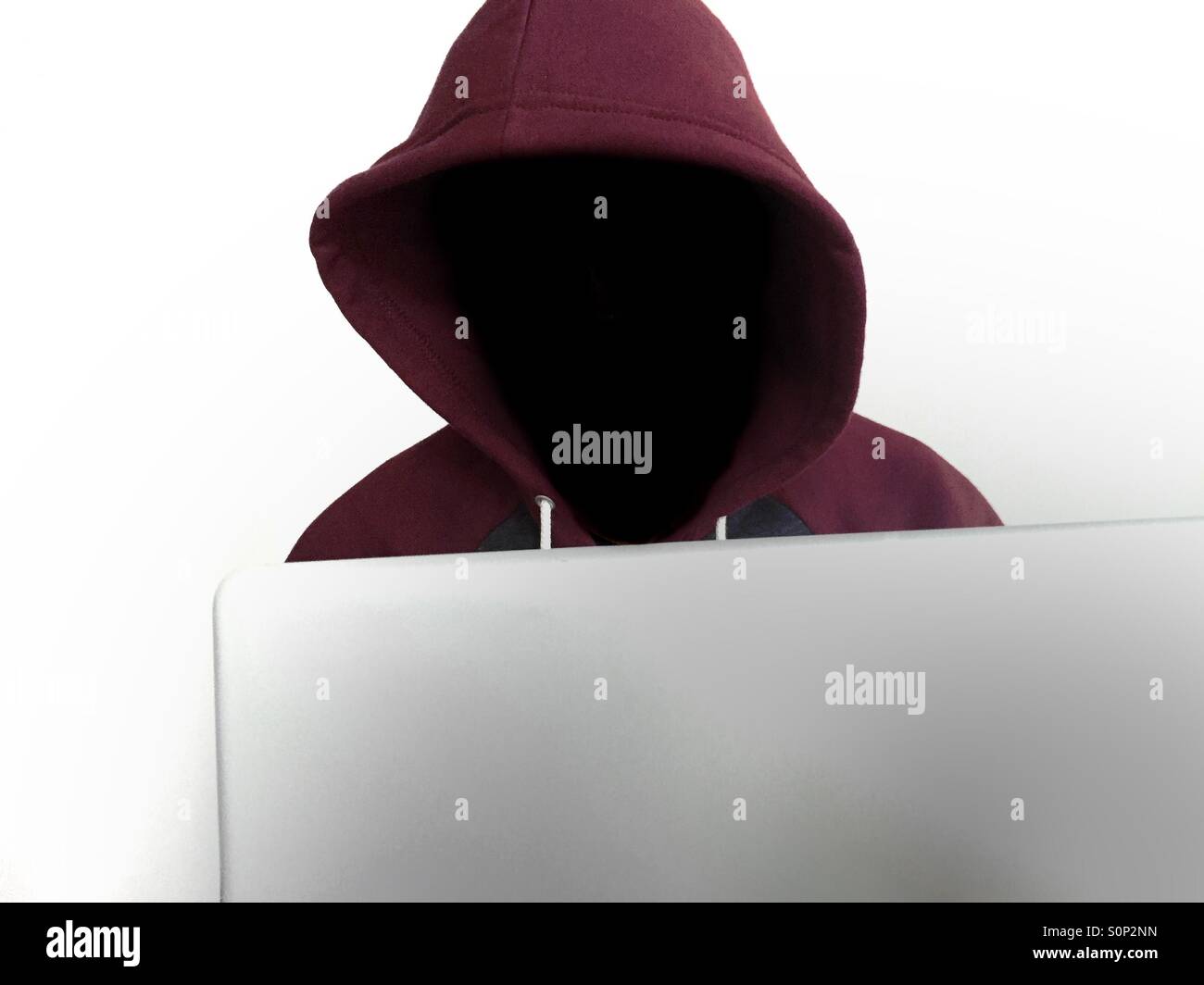 Hacker using a laptop - Smartphone Captured Stock Image