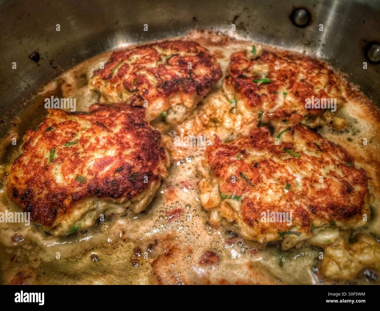Maryland style crab cakes in a pan - Smartphone Captured Stock Image