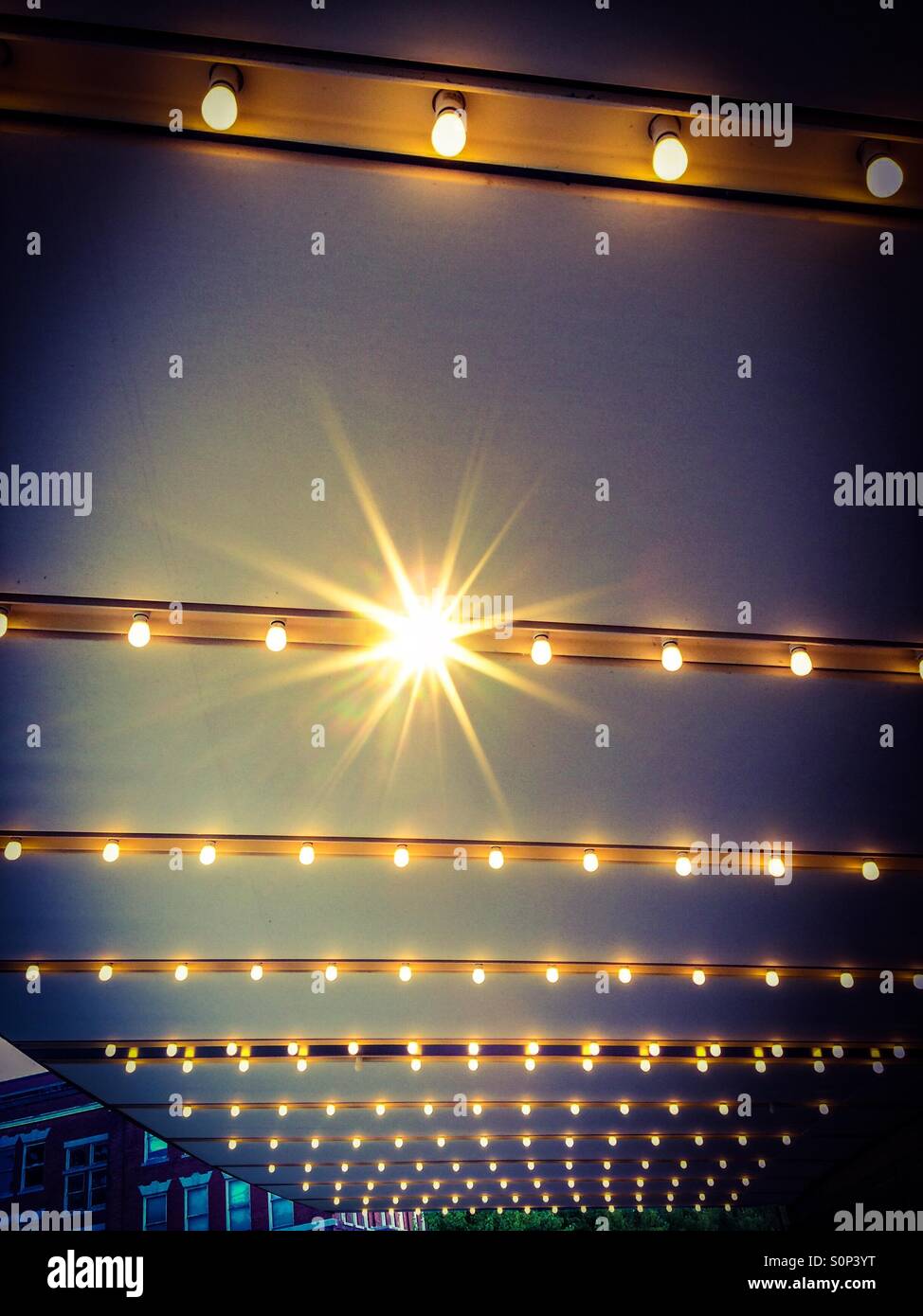 Marquee. Rows of ceiling lights, with an accent flare, in a theatre
