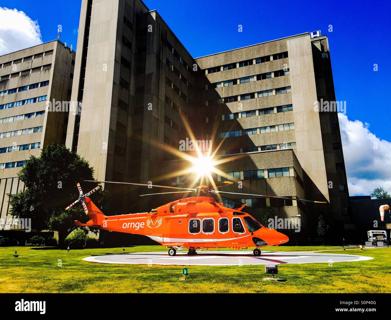 Helicopter. An air ambulance helicopter on the helipad outside a modern hospital, Ontario, Canada. The helicopter has landed. - Smartphone Captured Stock Image