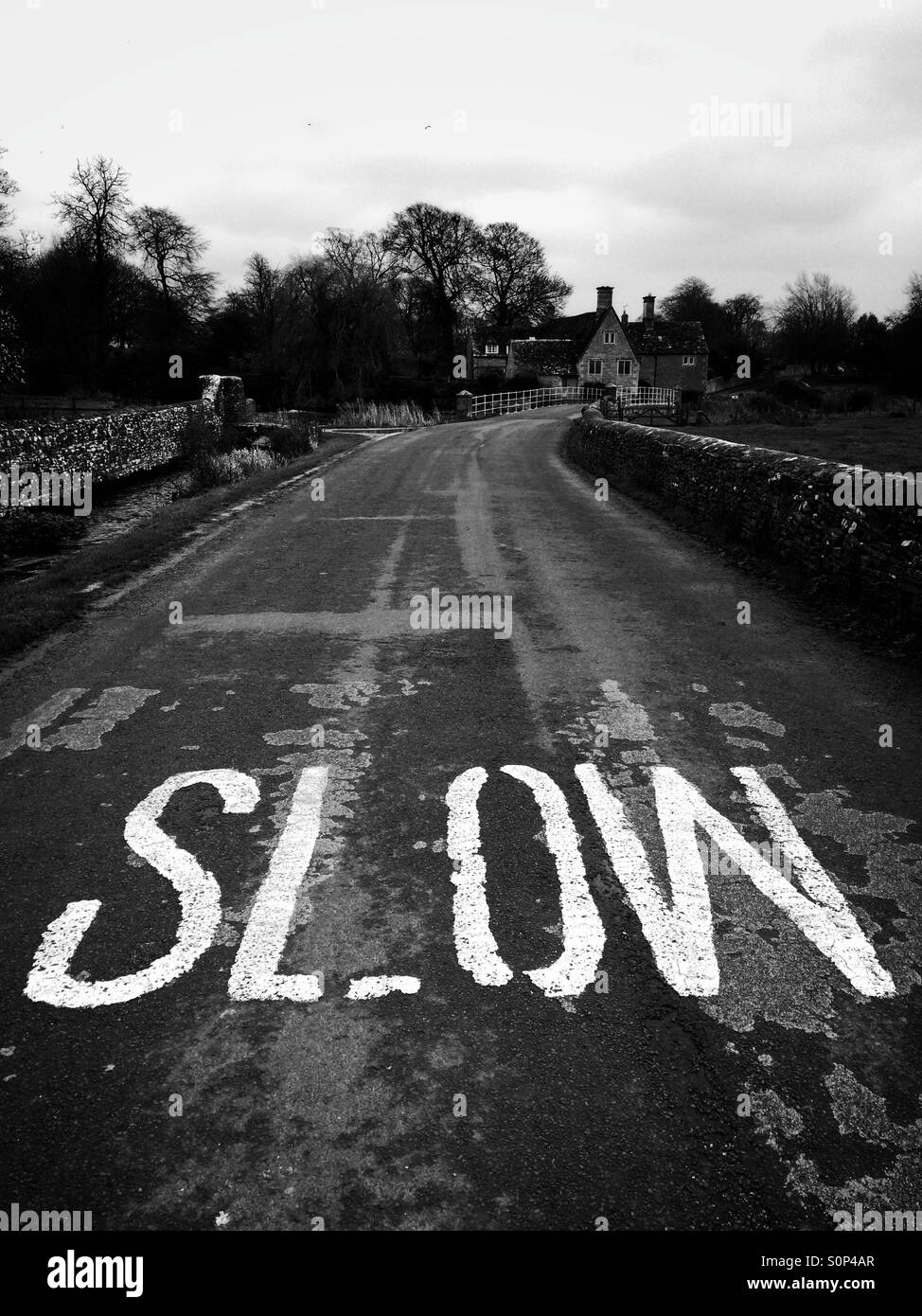 Slow warning sign on a country road in the Cotswolds UK - Smartphone Captured Stock Image