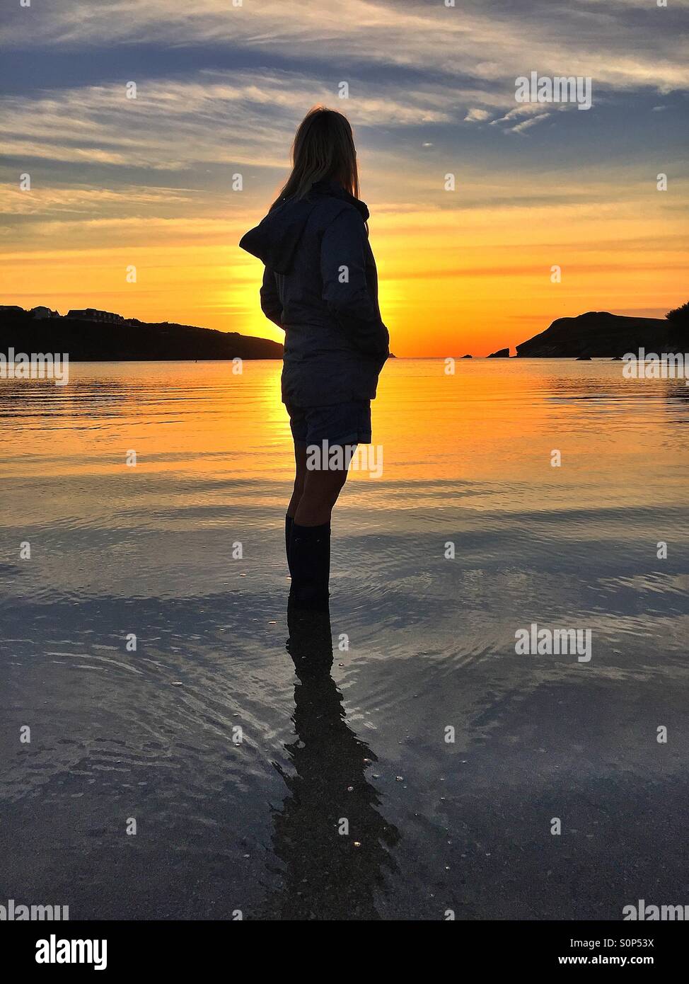 Woman watching the setting sun Stock Photo - Alamy