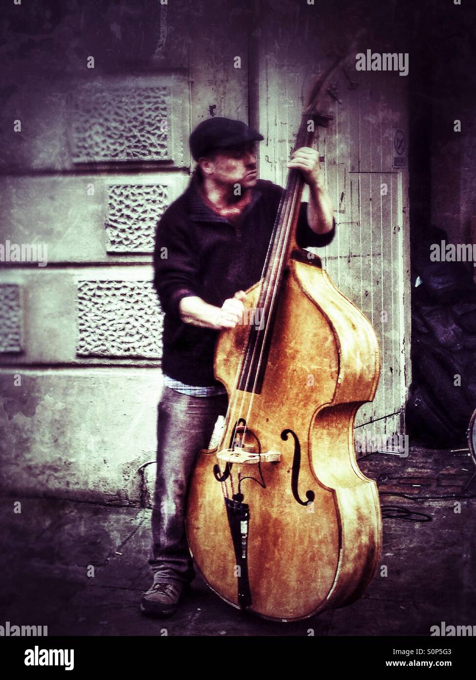 A double bass player busking in the street Stock Photo Alamy