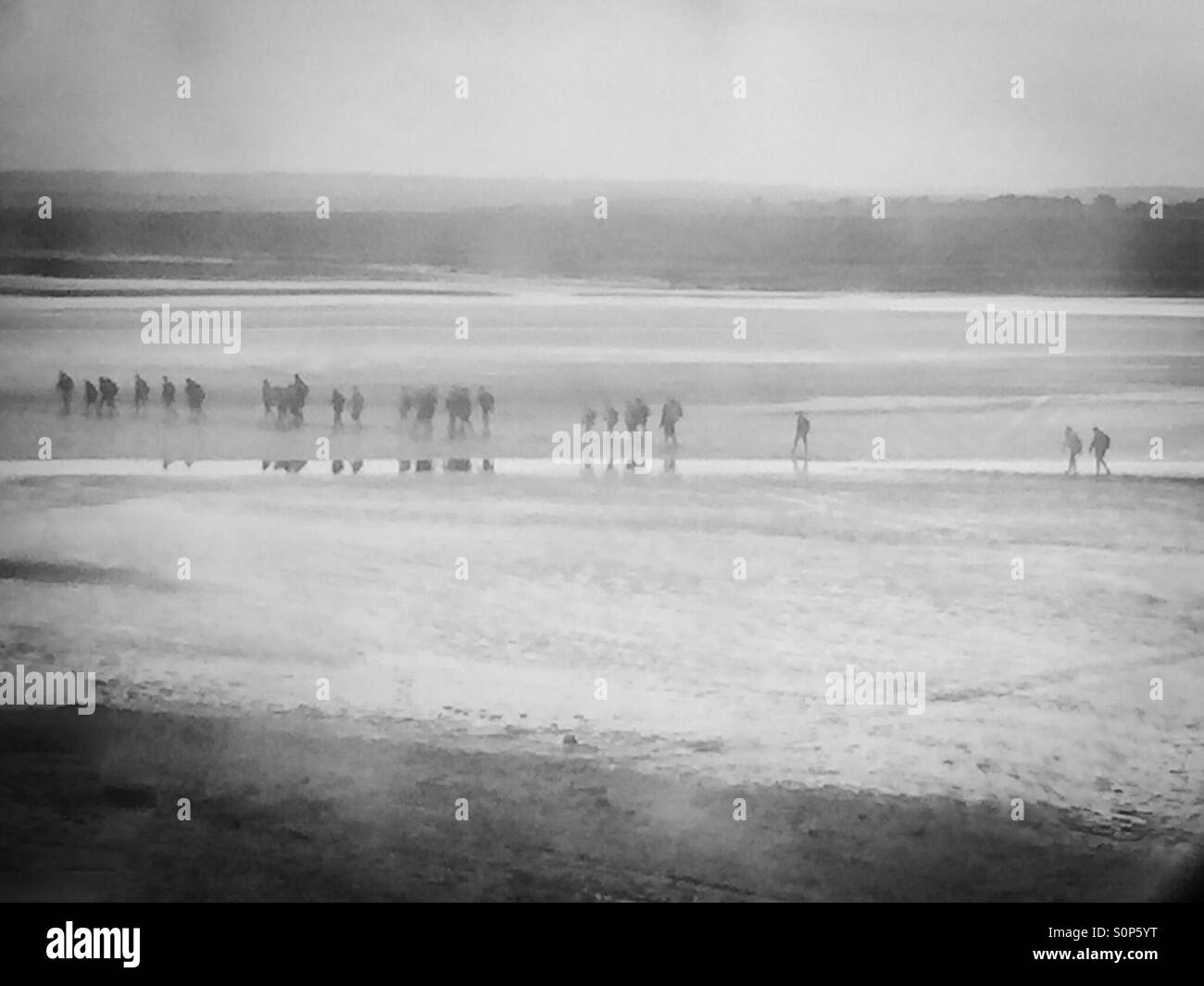 Mont Saint Michel mud walkers Stock Photo