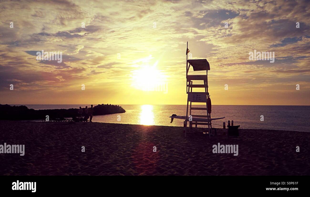 Sunset with the silhouette of a lifeguard station - Smartphone Captured Stock Image