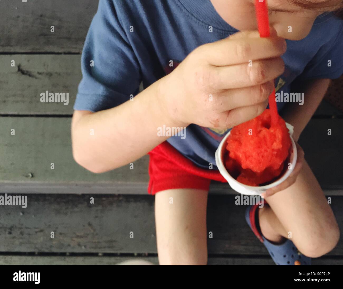 Boy eating snow cone. Stock Photo