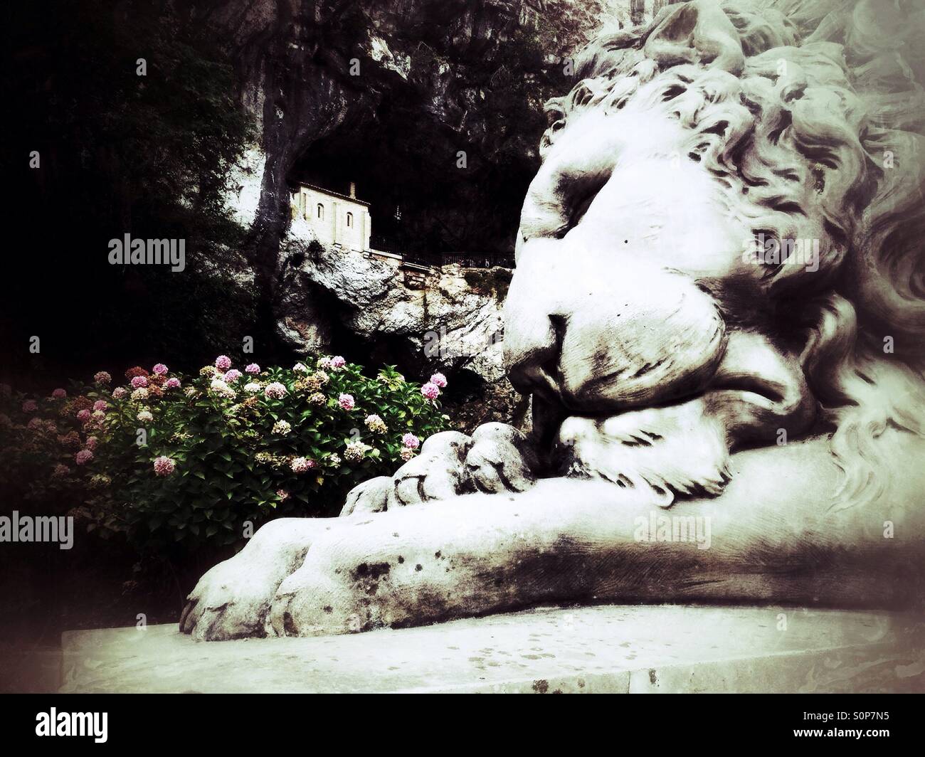 Lion sculpture and the Holy Cave of Covadonga in Asturias, Spain - Smartphone Captured Stock Image