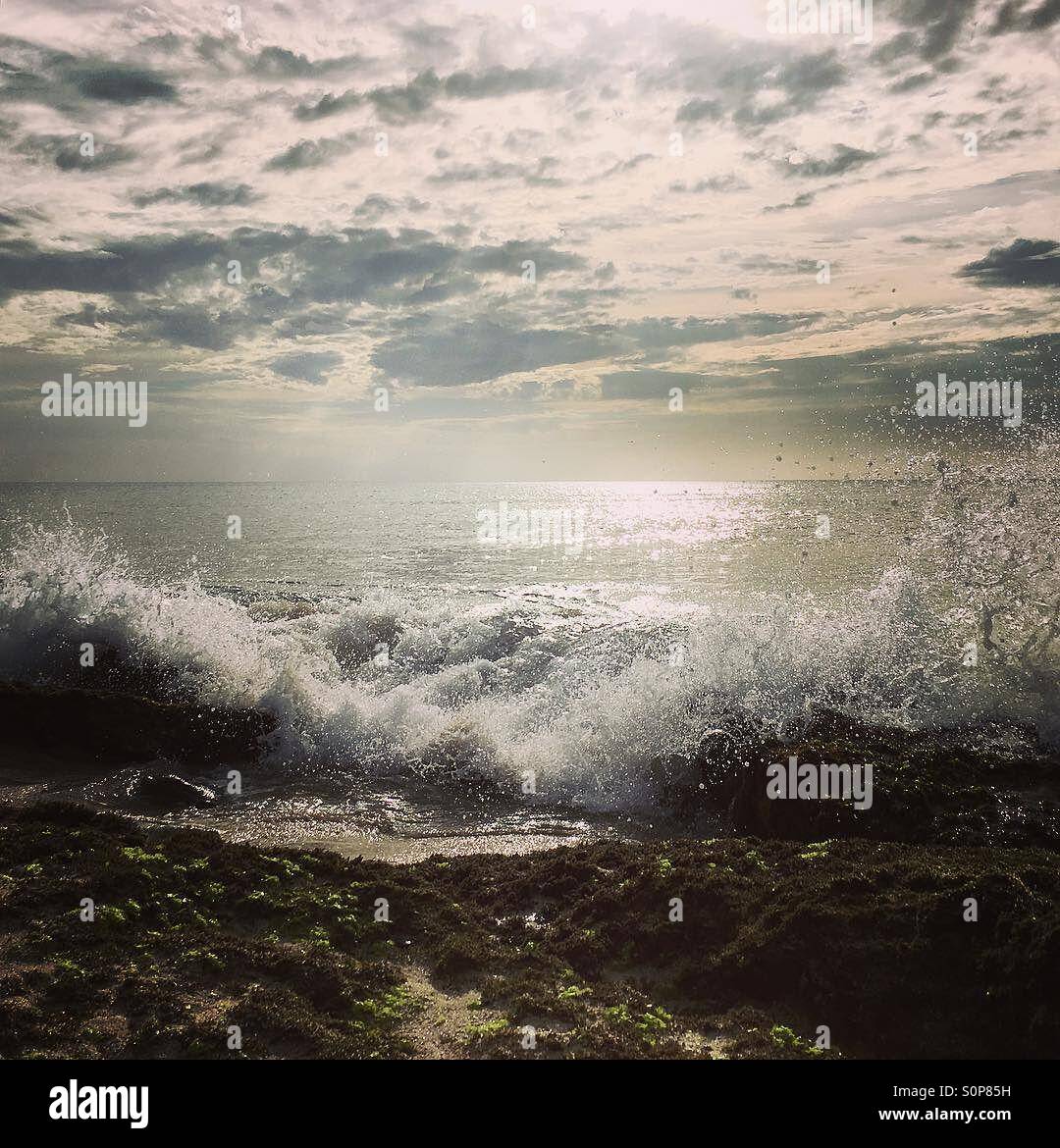 Waves crashing onto beach at early sunset - Smartphone Captured Stock Image