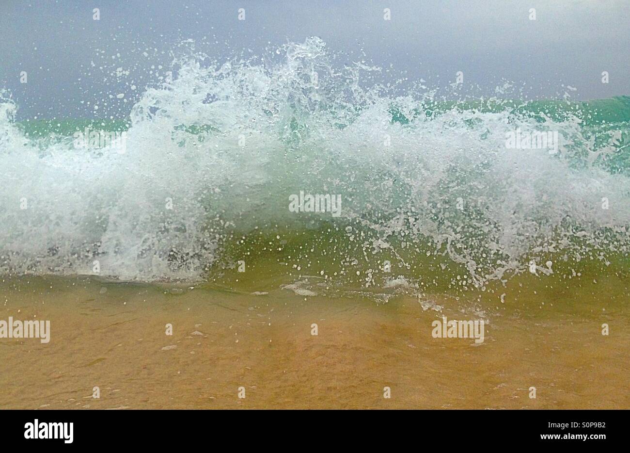 Breaking waves on a sandy beach - Smartphone Captured Stock Image