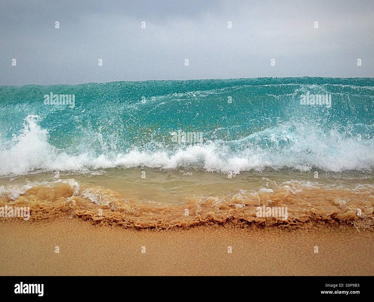 First break of a wave on a sandy beach - Smartphone Captured Stock Image