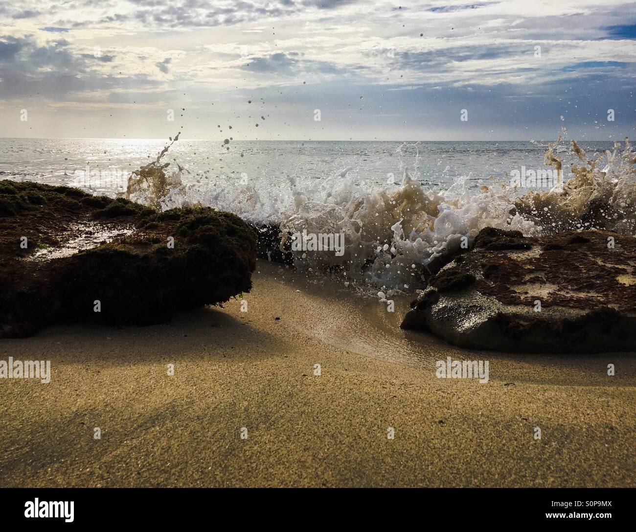 Splashing waves in between rocks - Smartphone Captured Stock Image