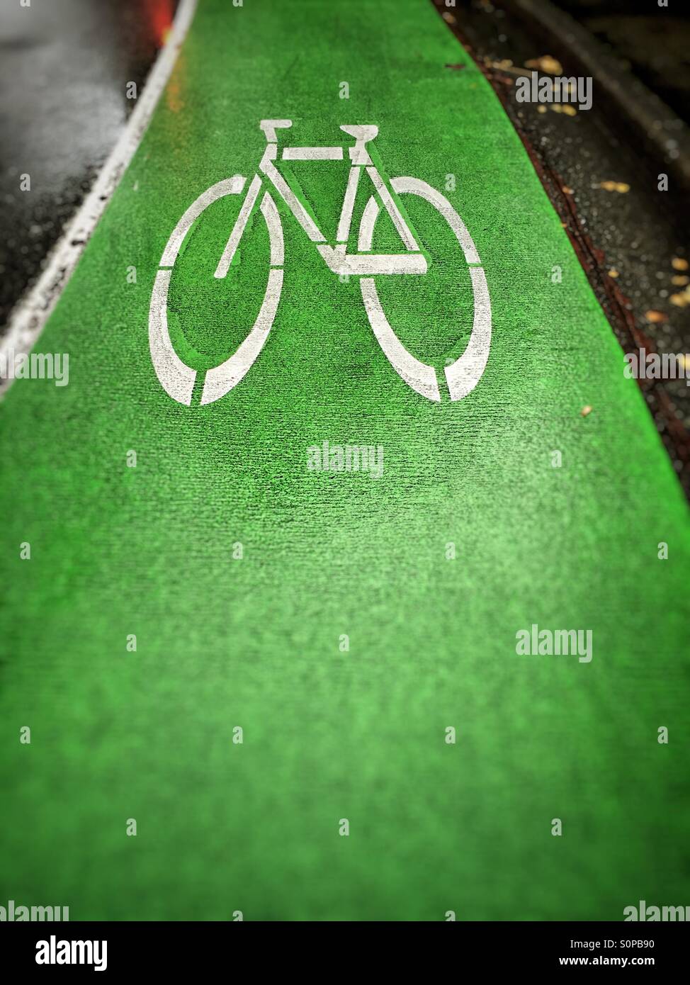 Bicycle lane on roadway with green painted lane. - Smartphone Captured Stock Image