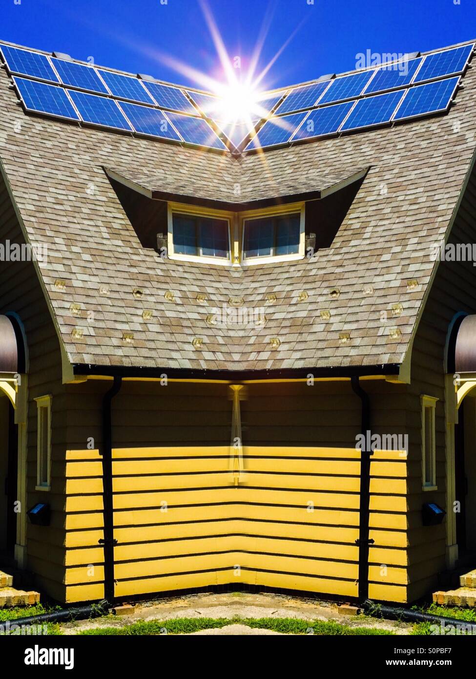 Rooftop Solar panels on a house, Ontario, Canada. The sun shines brightly in a flare. Sustainable, renewable, green energy. Small is beautiful. - Smartphone Captured Stock Image