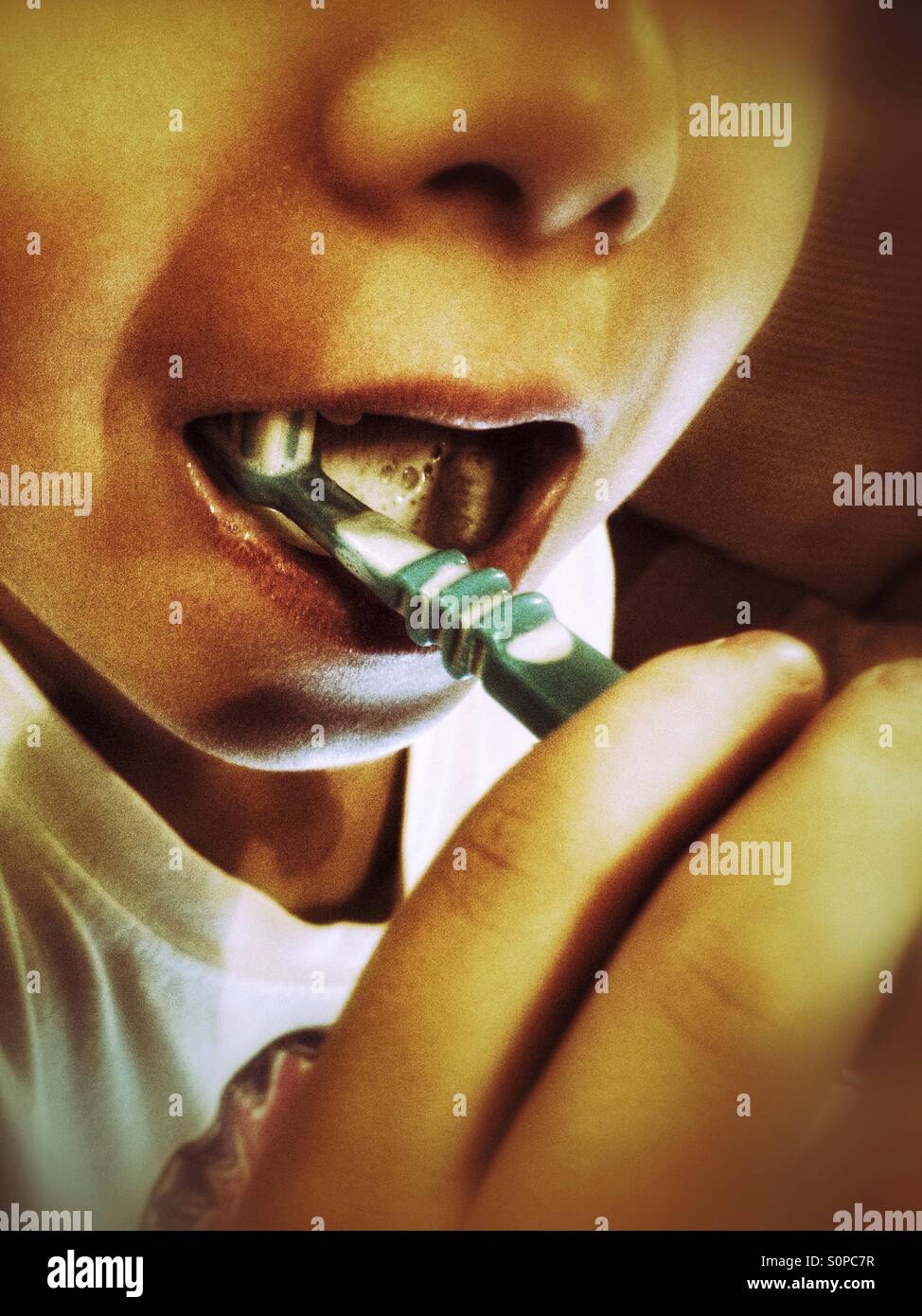 A boy brushing his teeth. - Smartphone Captured Stock Image