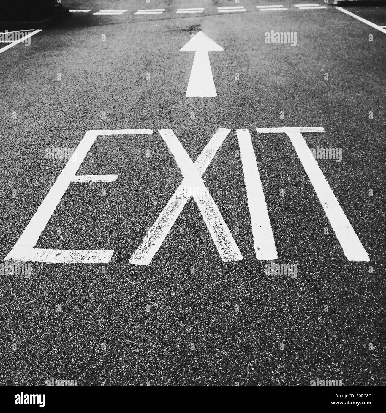 Exit sign and arrow painted on road surface Stock Photo