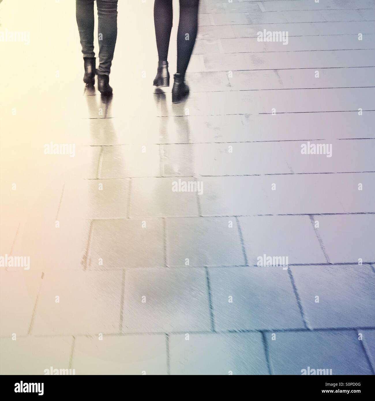 Rainy day in the city. Women feet and legs on a pavement. - Smartphone Captured Stock Image