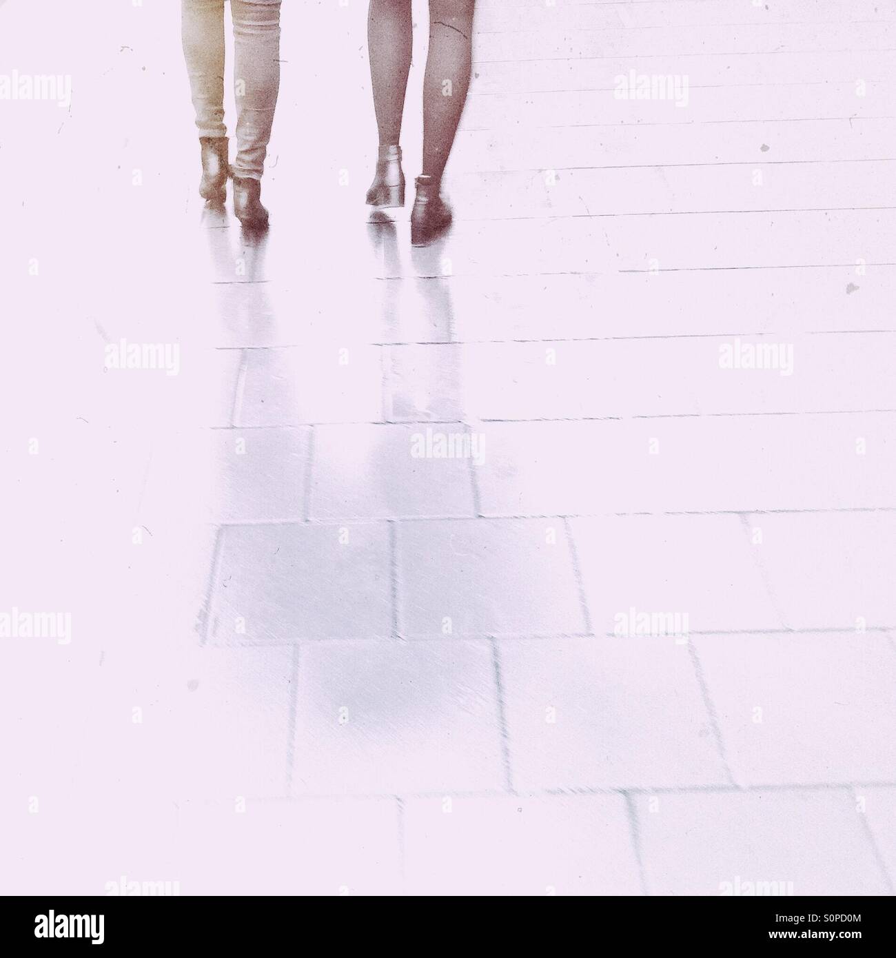 Rainy day in the city. Women feet and legs on a pavement. - Smartphone Captured Stock Image