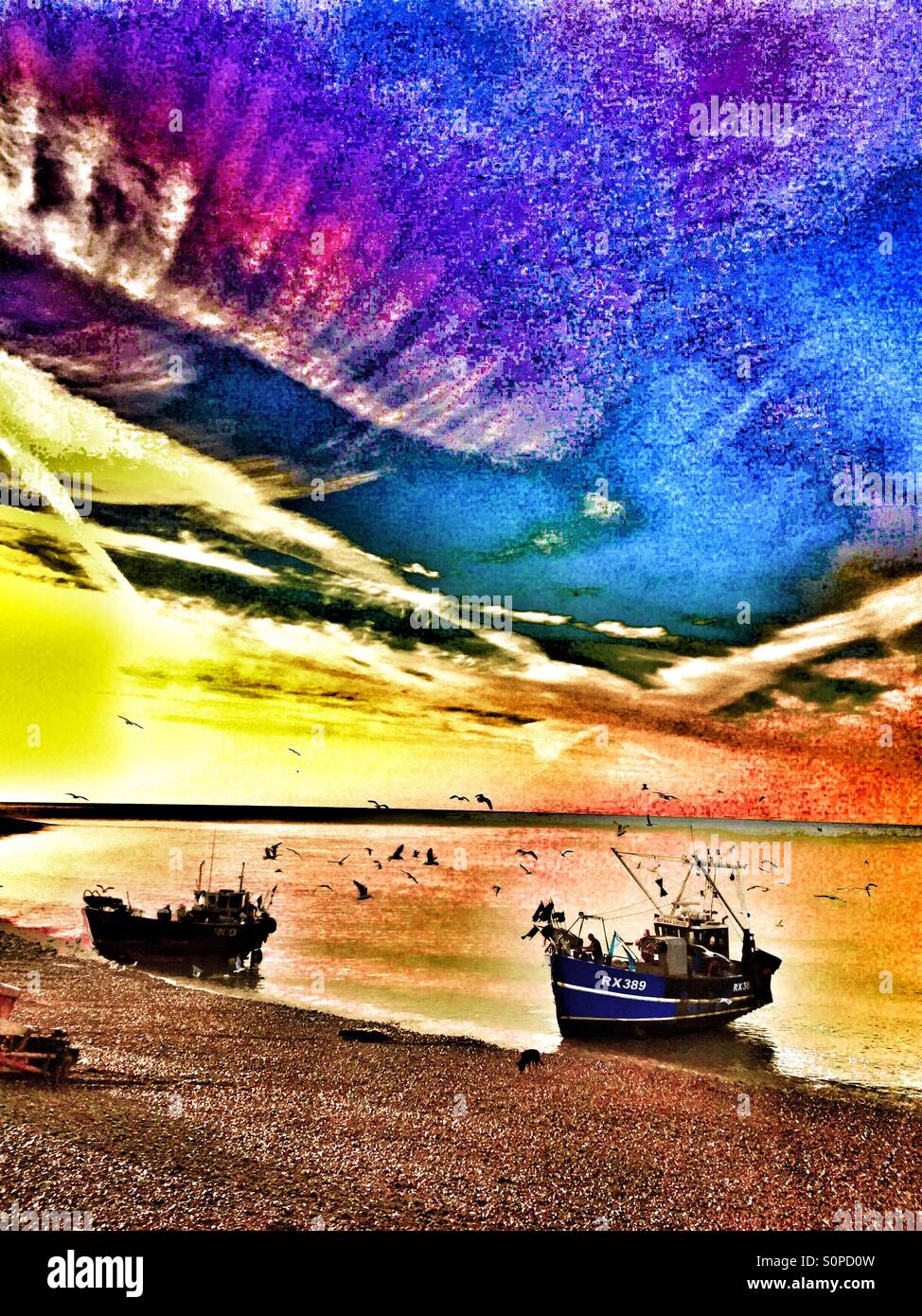 Fishing boats landing at sunrise on Hastings Stade beach, East Sussex, England, UK - Smartphone Captured Stock Image
