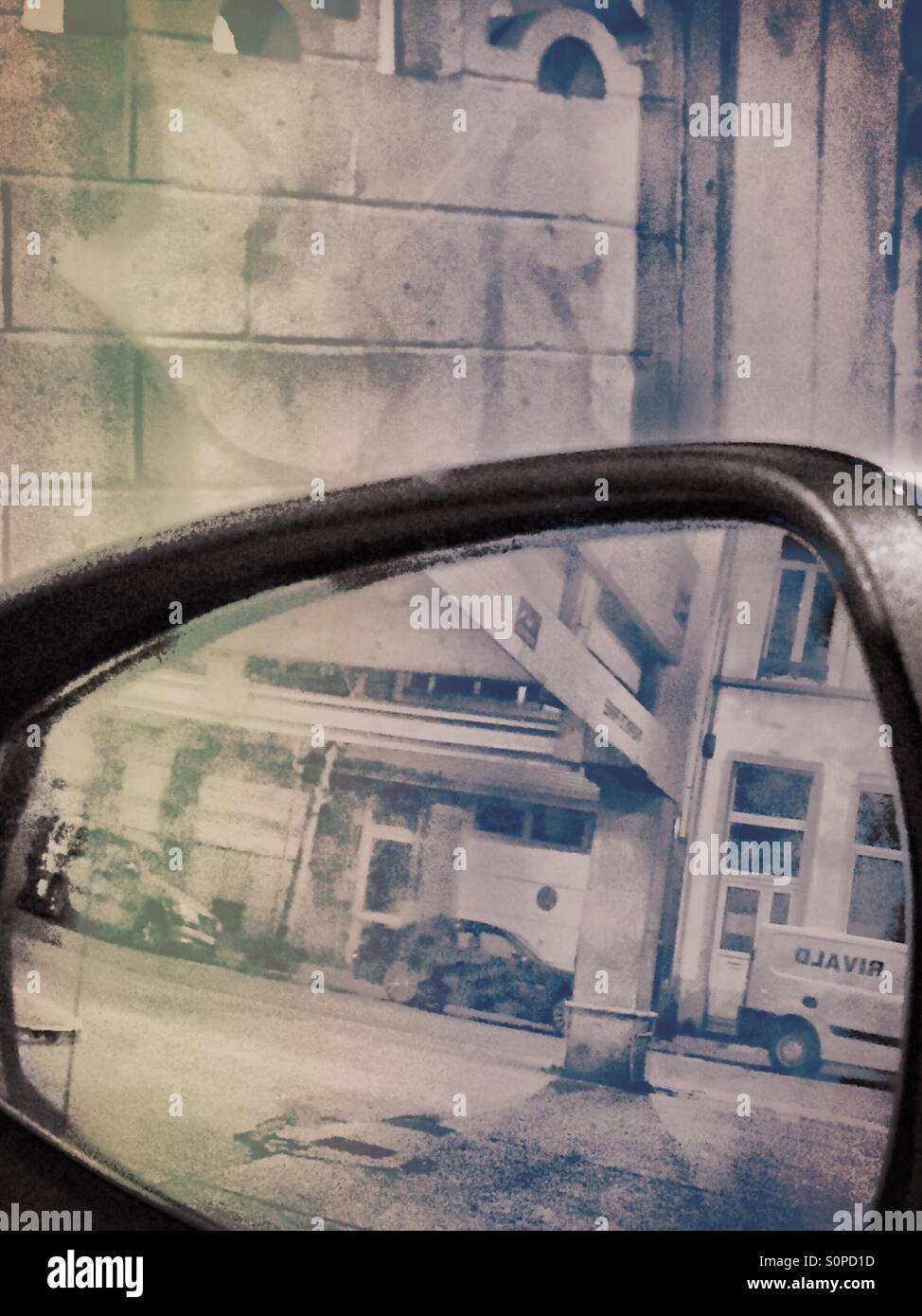 Building structures seen through a rear view mirror - Smartphone Captured Stock Image