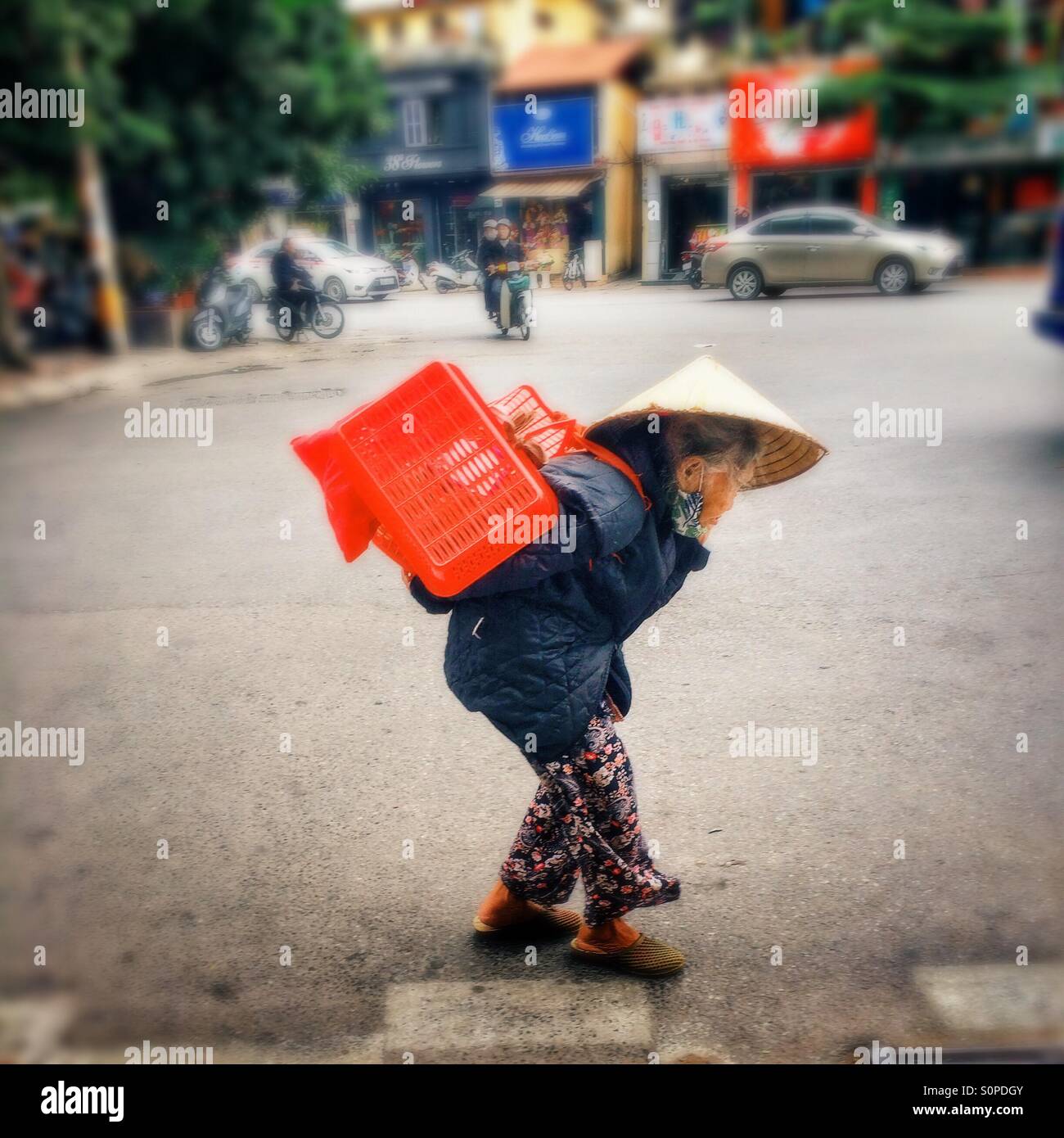 Old Vietnamese woman carrying heavy load - Smartphone Captured Stock Image