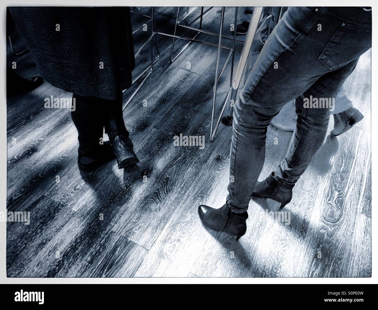 Social gathering on wooden floor - Smartphone Captured Stock Image