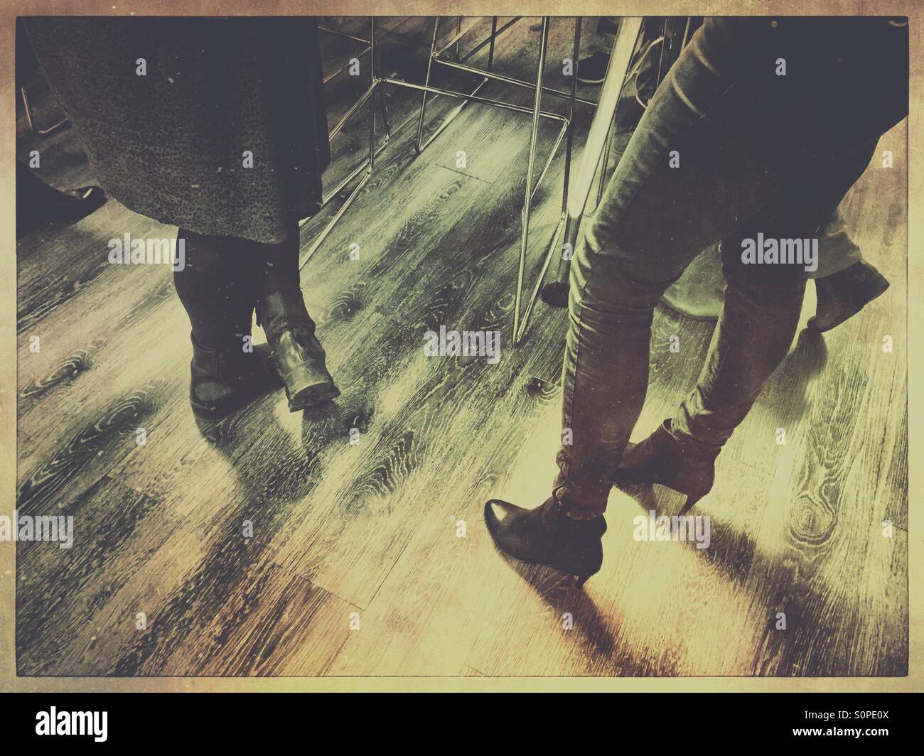 Social gathering on wooden floor - Smartphone Captured Stock Image