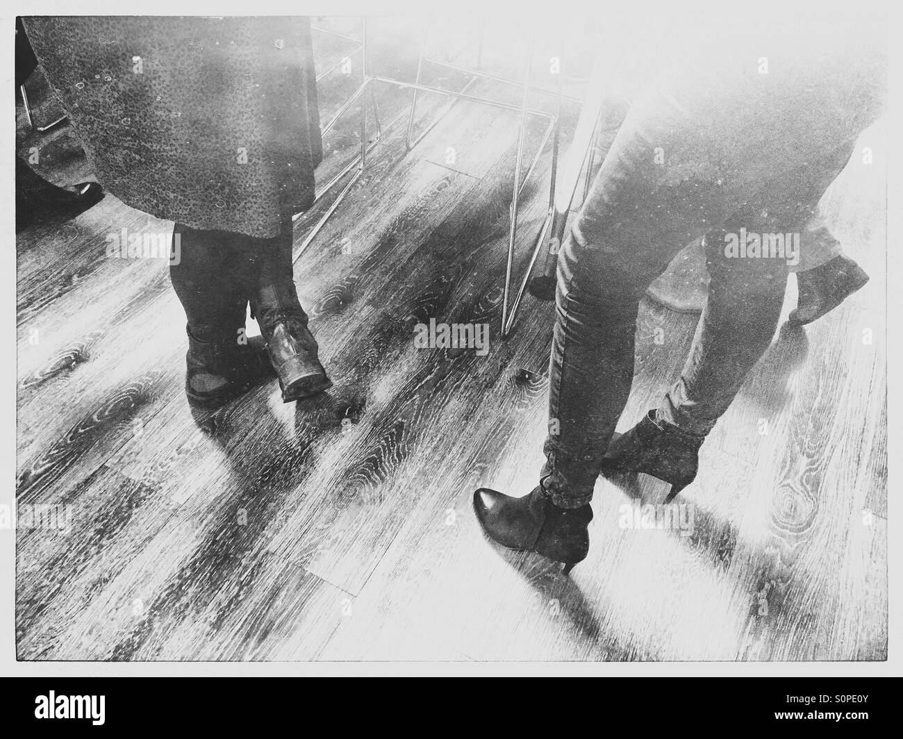 Social gathering on wooden floor - Smartphone Captured Stock Image