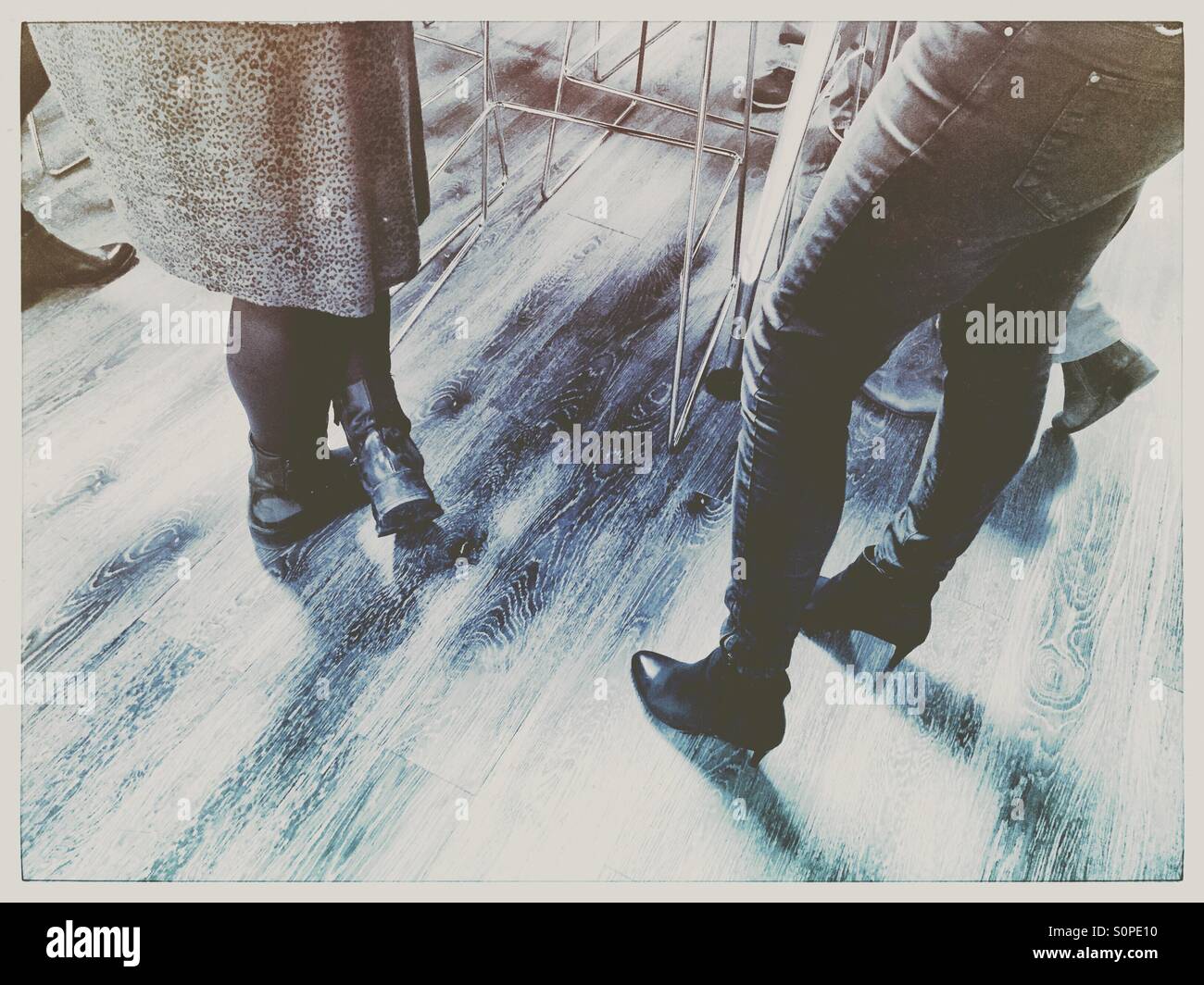 Social gathering on wooden floor - Smartphone Captured Stock Image