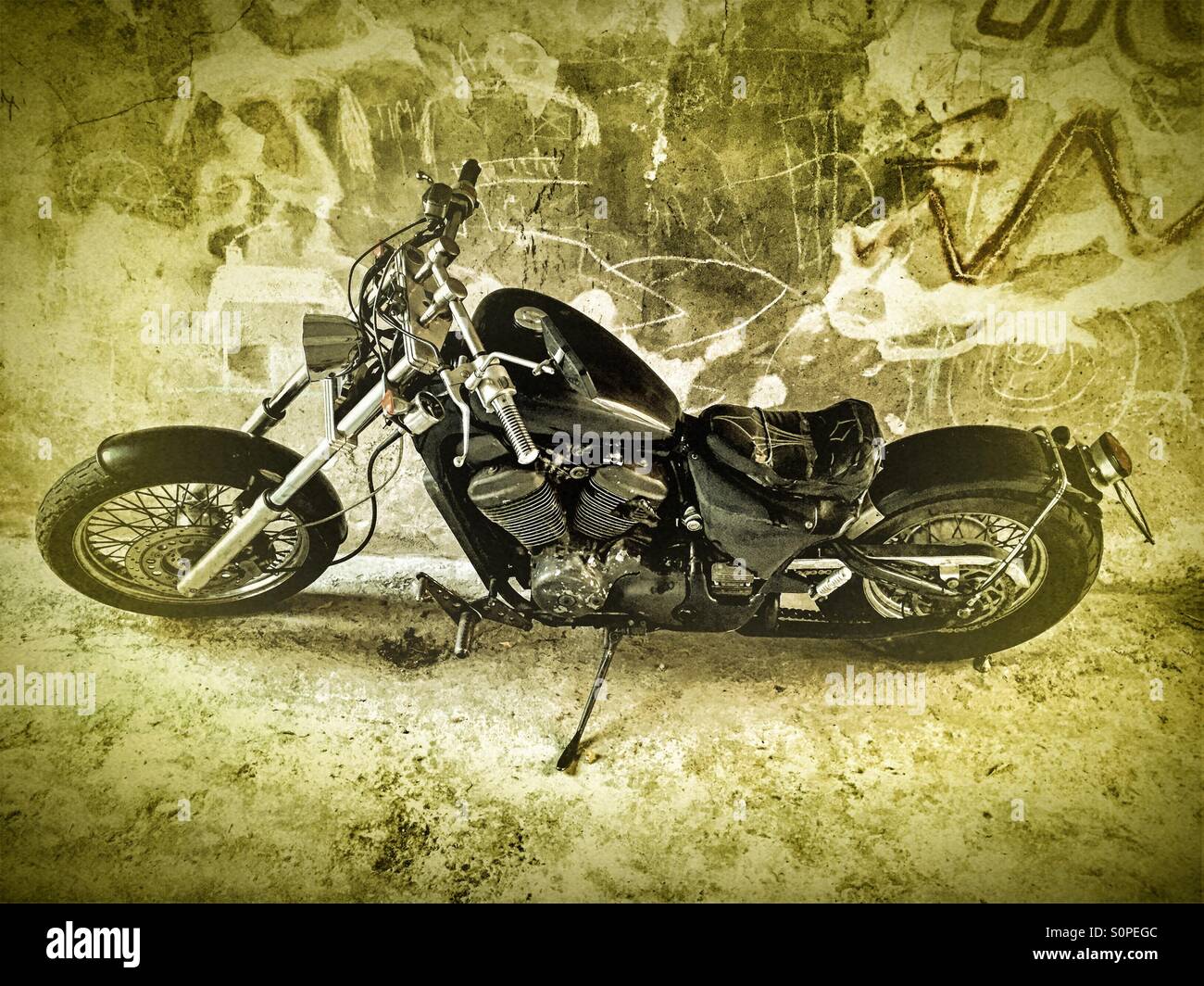 Motorcycle parked in front of a grunge wall - Smartphone Captured Stock Image