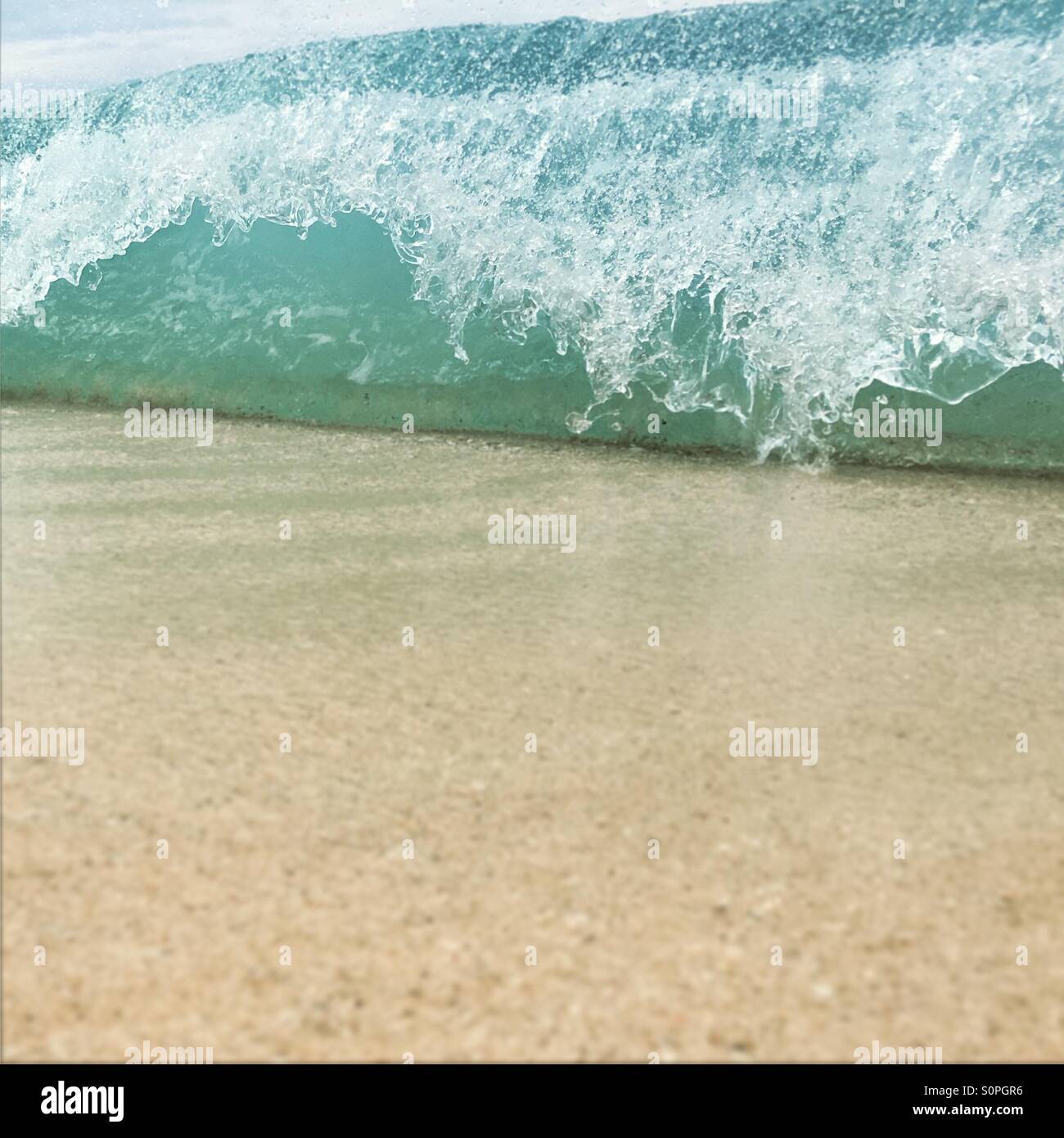 Close up of breaking wave onto a sandy beach - Smartphone Captured Stock Image