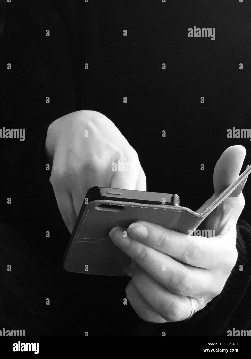 Closeup of the hands of a woman using a smartphone Stock Photo
