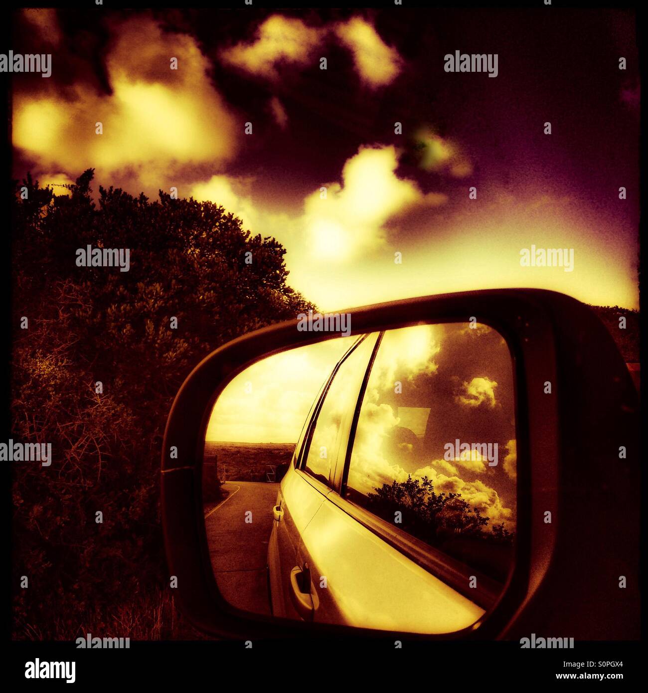 Clouds reflected in side view mirror Stock Photo Alamy