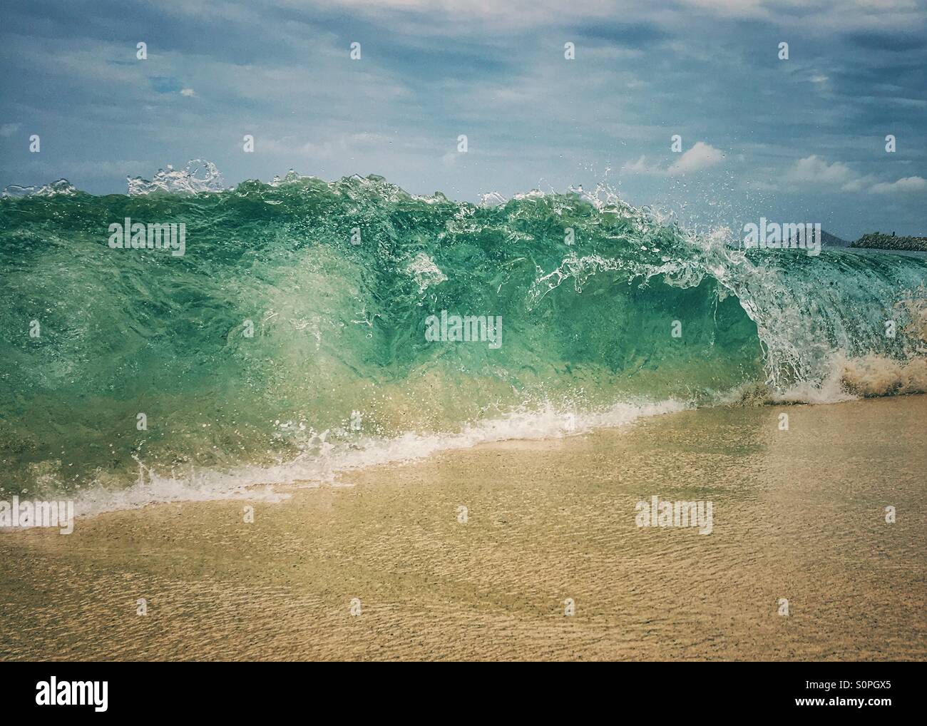 Wave crashing onto beach with funnel - Smartphone Captured Stock Image