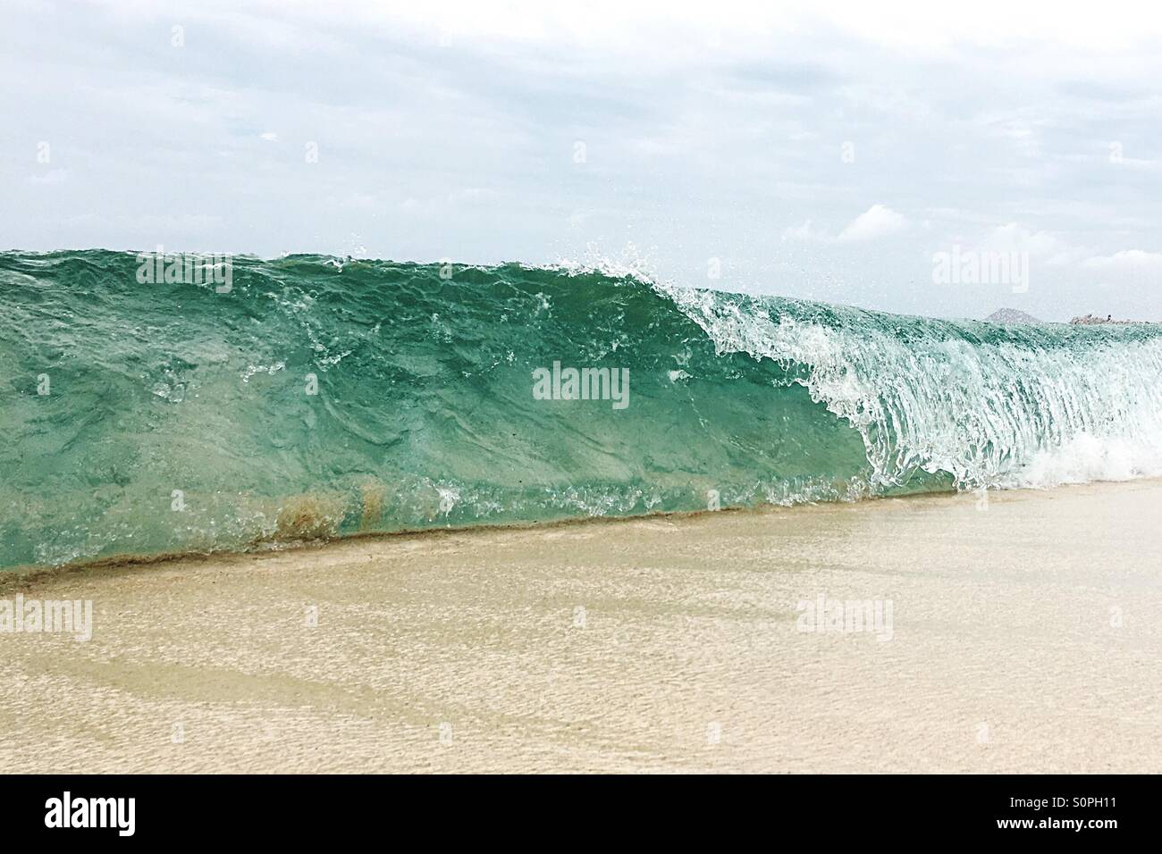Barrel wave breaking on the beach - Smartphone Captured Stock Image