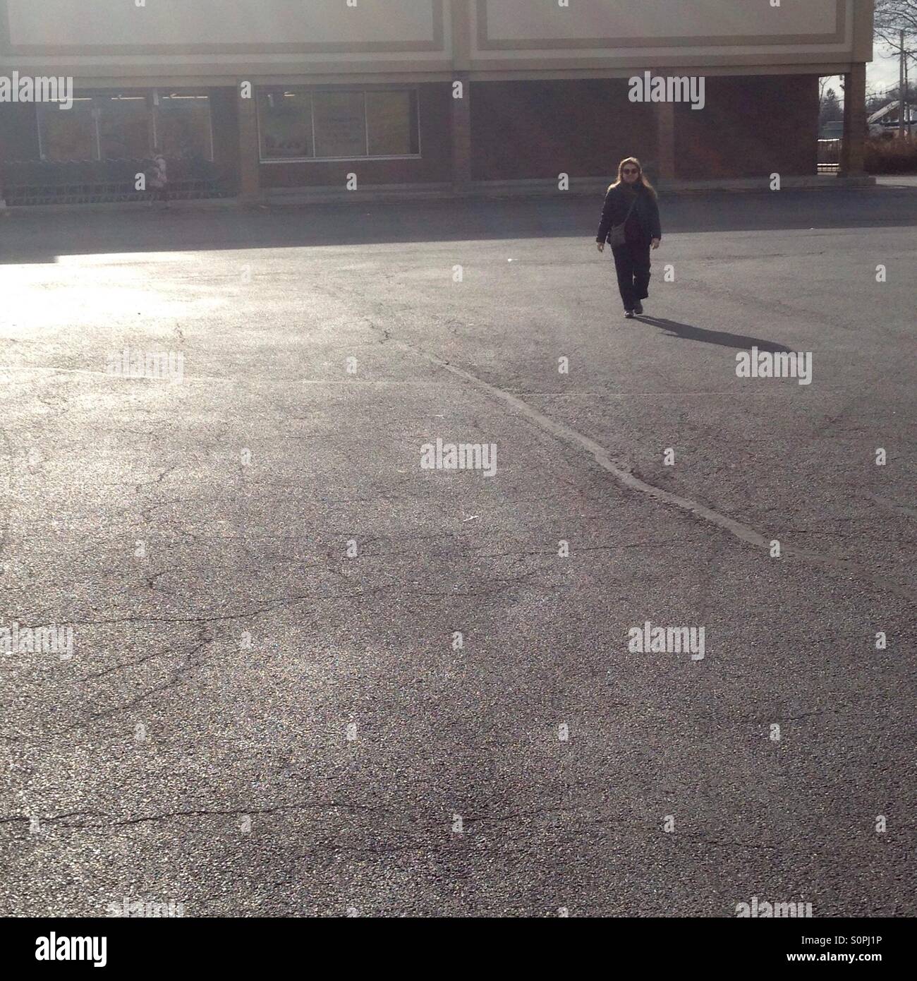 Women walking in empt parking lot - Smartphone Captured Stock Image