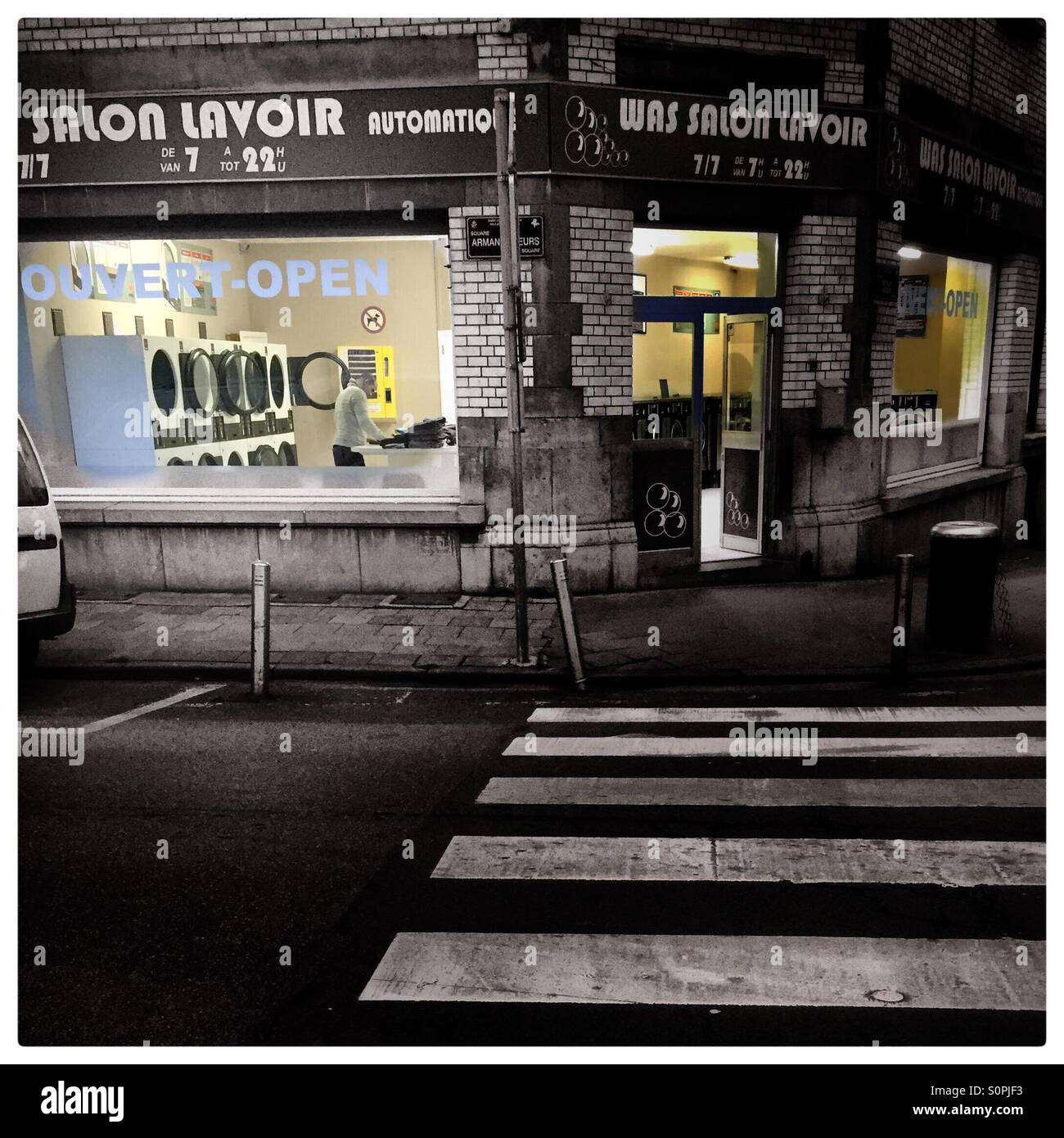 Late night laundry chore at the laundromat. Brussels, Belgium, Europe - Smartphone Captured Stock Image